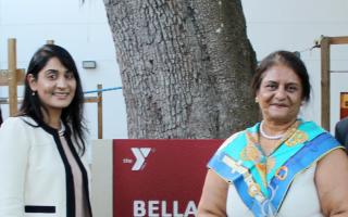 Bella Patel standing with three family members in namesake courtyard at Campo YMCA