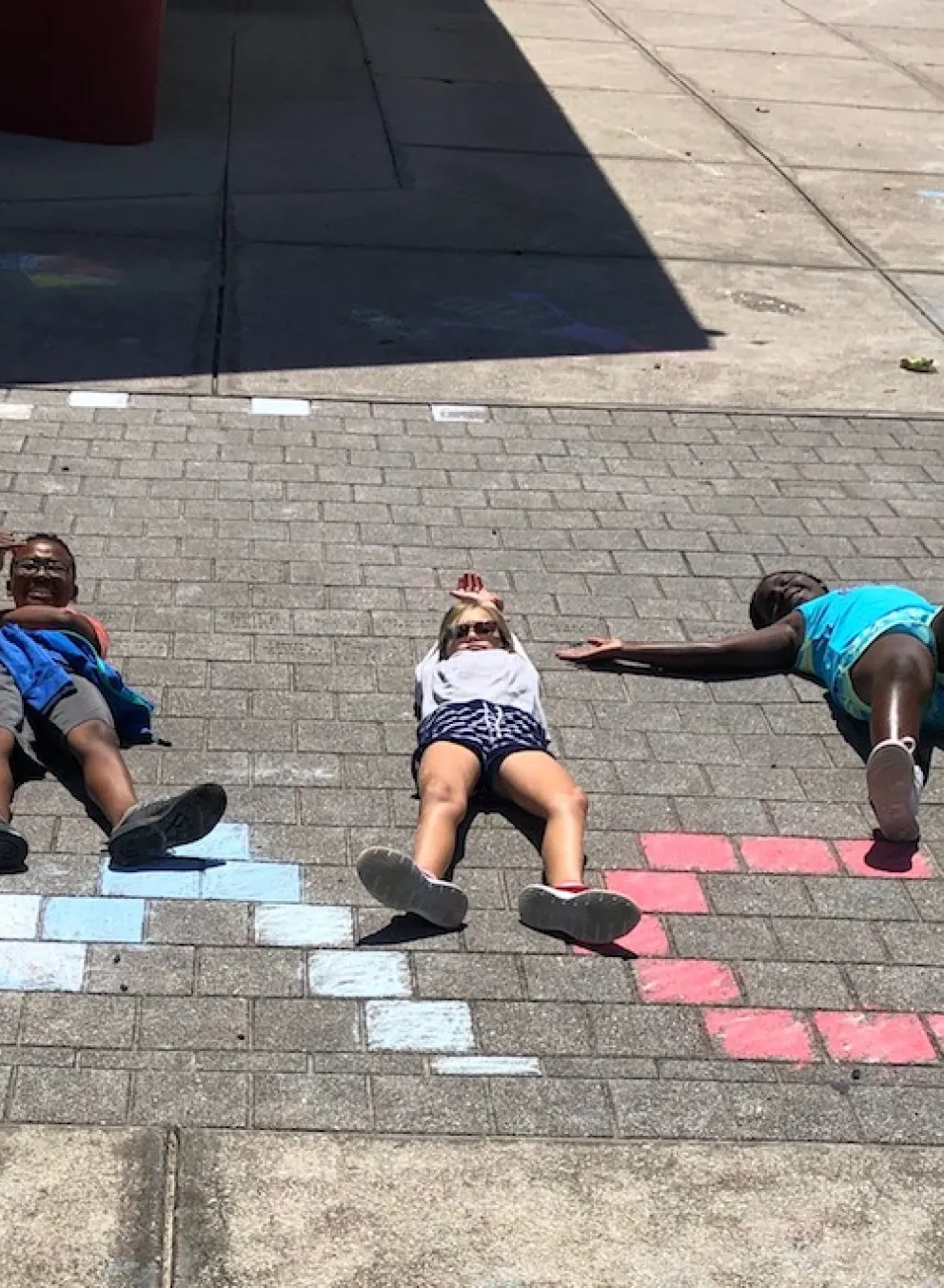 kids playing with chalk spelling ymca
