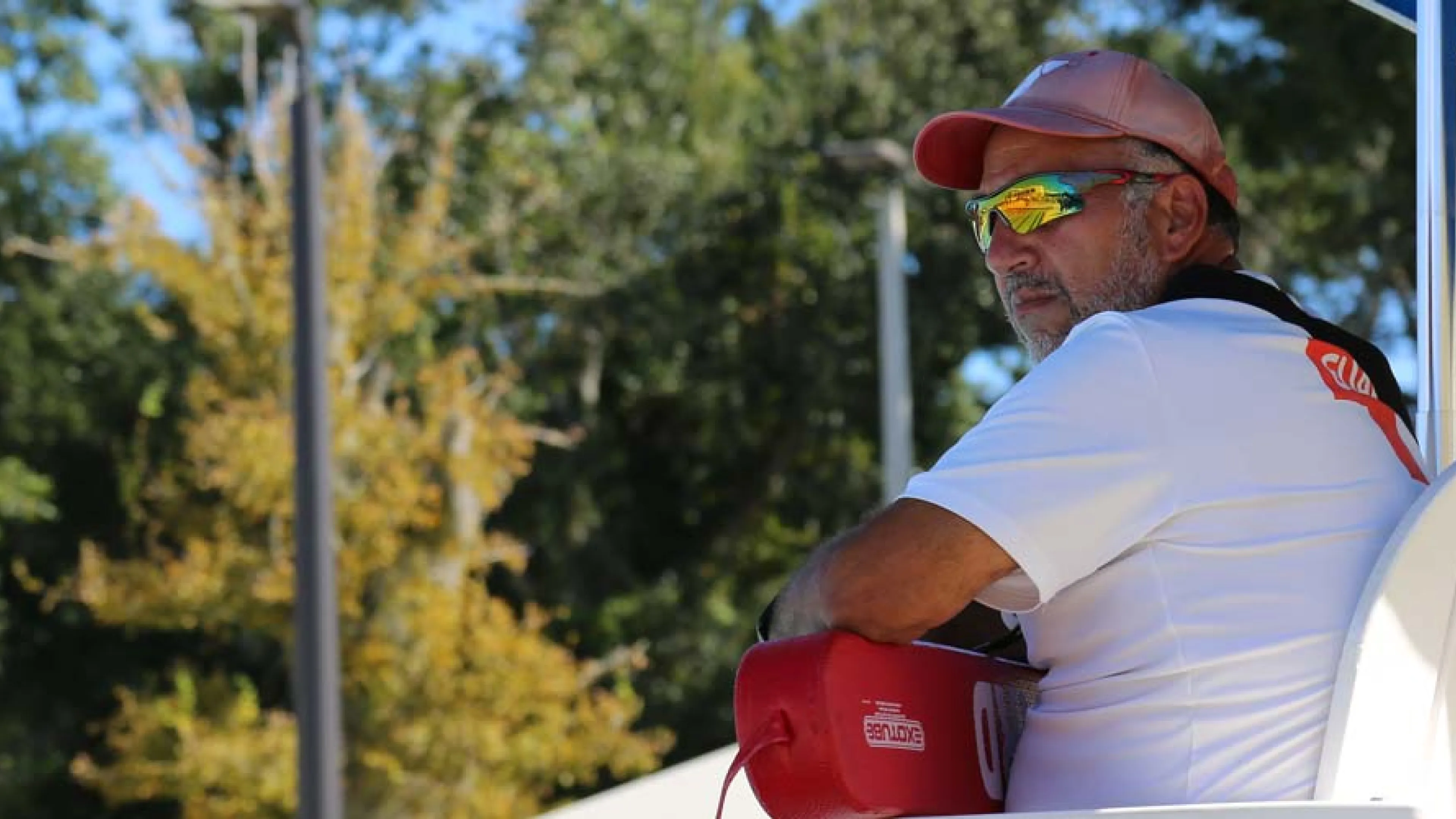 lifeguard with hat watching pool