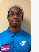 headshot of male personal trainer wearing blue YMCA polo beige background