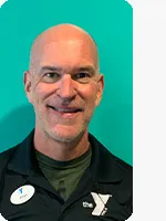 headshot of male personal trainer wearing black YMCA polo teal background