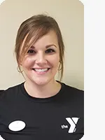 headshot of female personal trainer wearing black YMCA shirt beige background