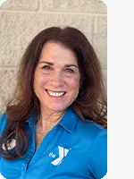 headshot of female personal trainer wearing blue YMCA polo beige background