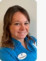 headshot of female personal trainer wearing blue YMCA polo gray background