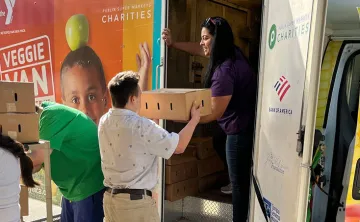 Elizabeth Roman unloading the Veggie Van.